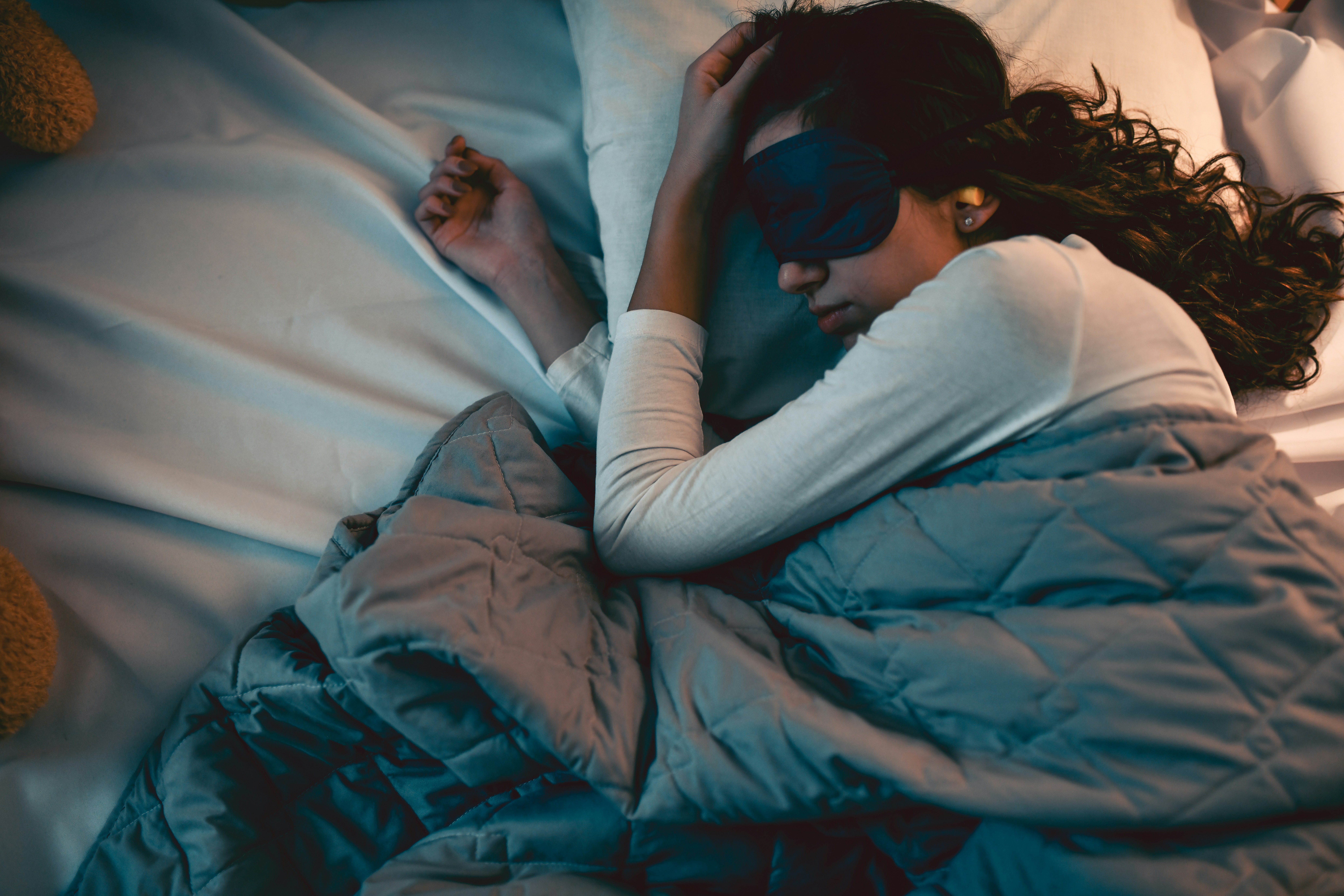 A person sleeps soundly in bed after beating insomnia.