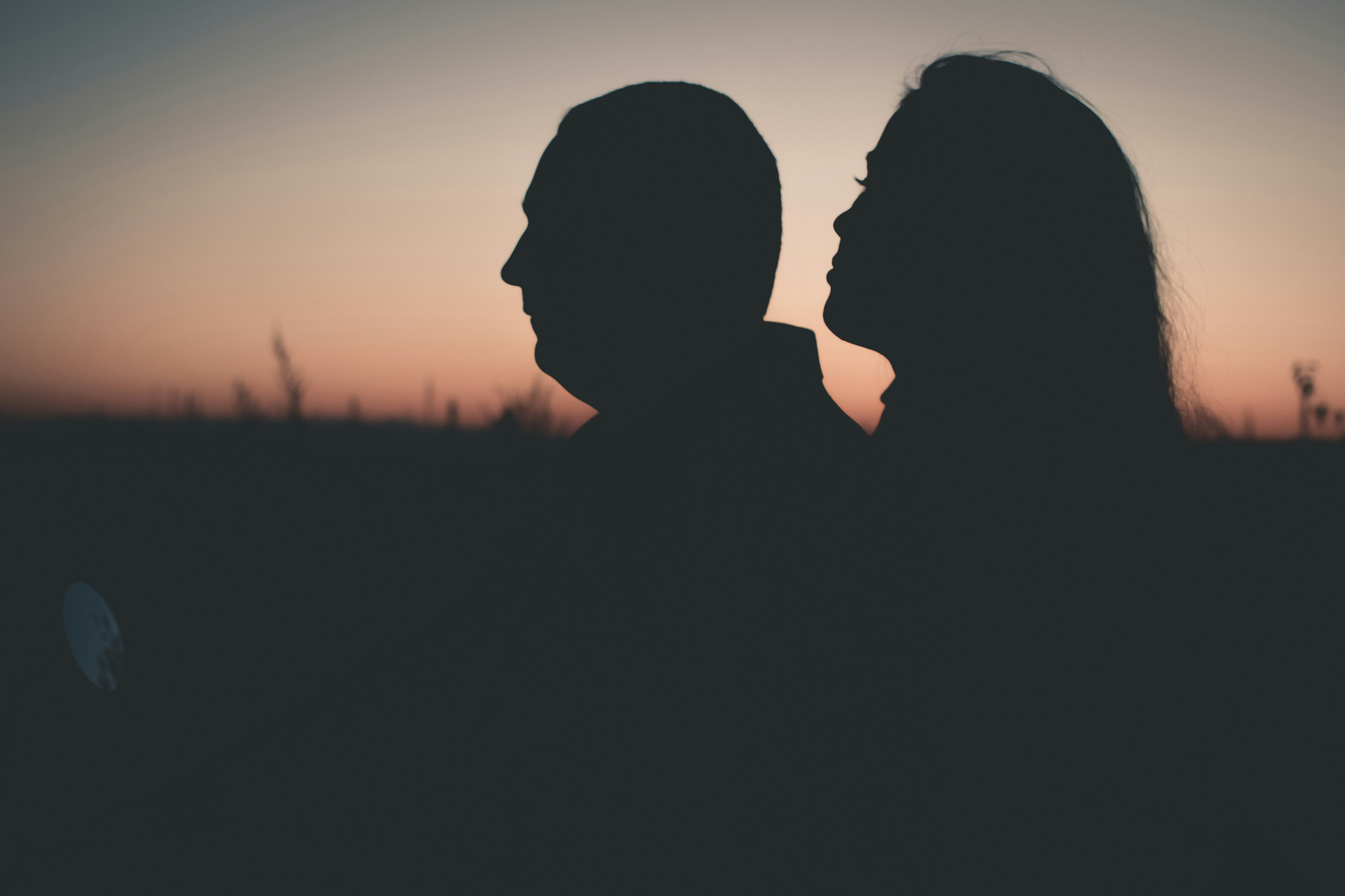 Silhouette of a couple in high conflict as they decide to seek therapy.